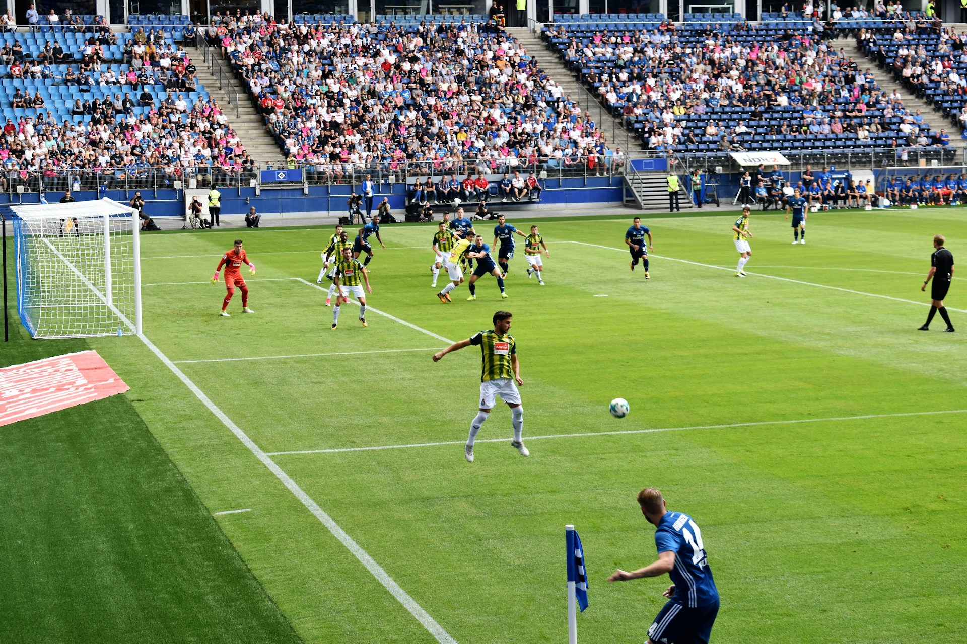 men playing soccer of soccer field during daytime