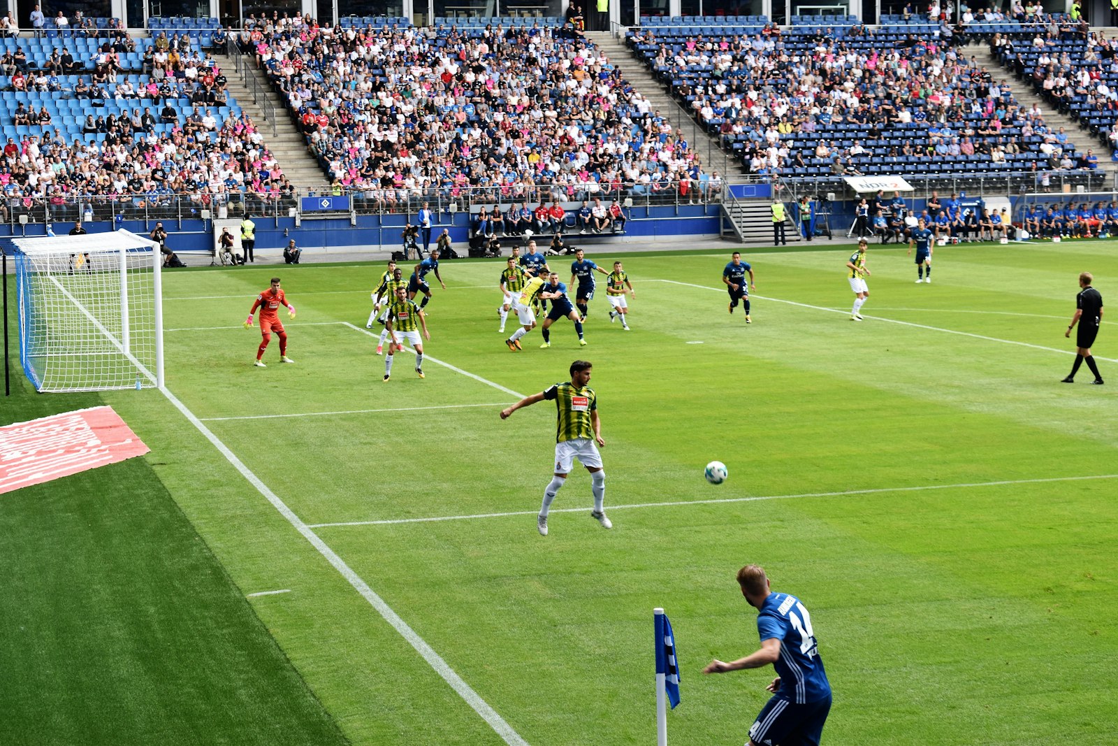 Two soccer players competing for the ball during an outdoor club match — the kind of late-game contested moment when calf and hamstring cramps decide who wins.