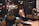 A cheerful group of people reading news articles together in a cozy cafe.