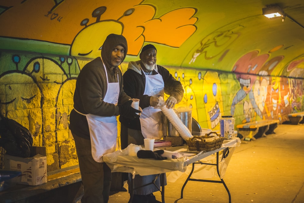 two men wearing aprons