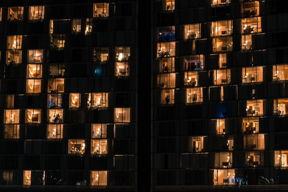 a very tall building with lots of windows lit up at night