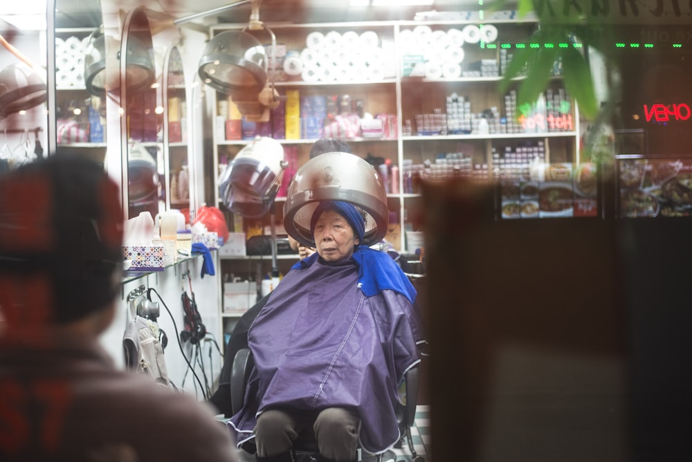 woman sitting on salon chair inside room