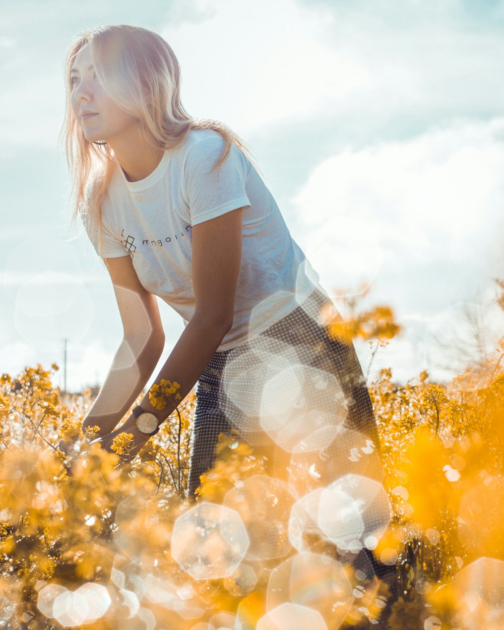 woman standing on yellow flower field