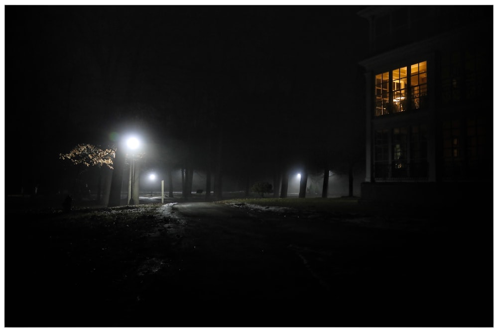 a dark street at night with street lights