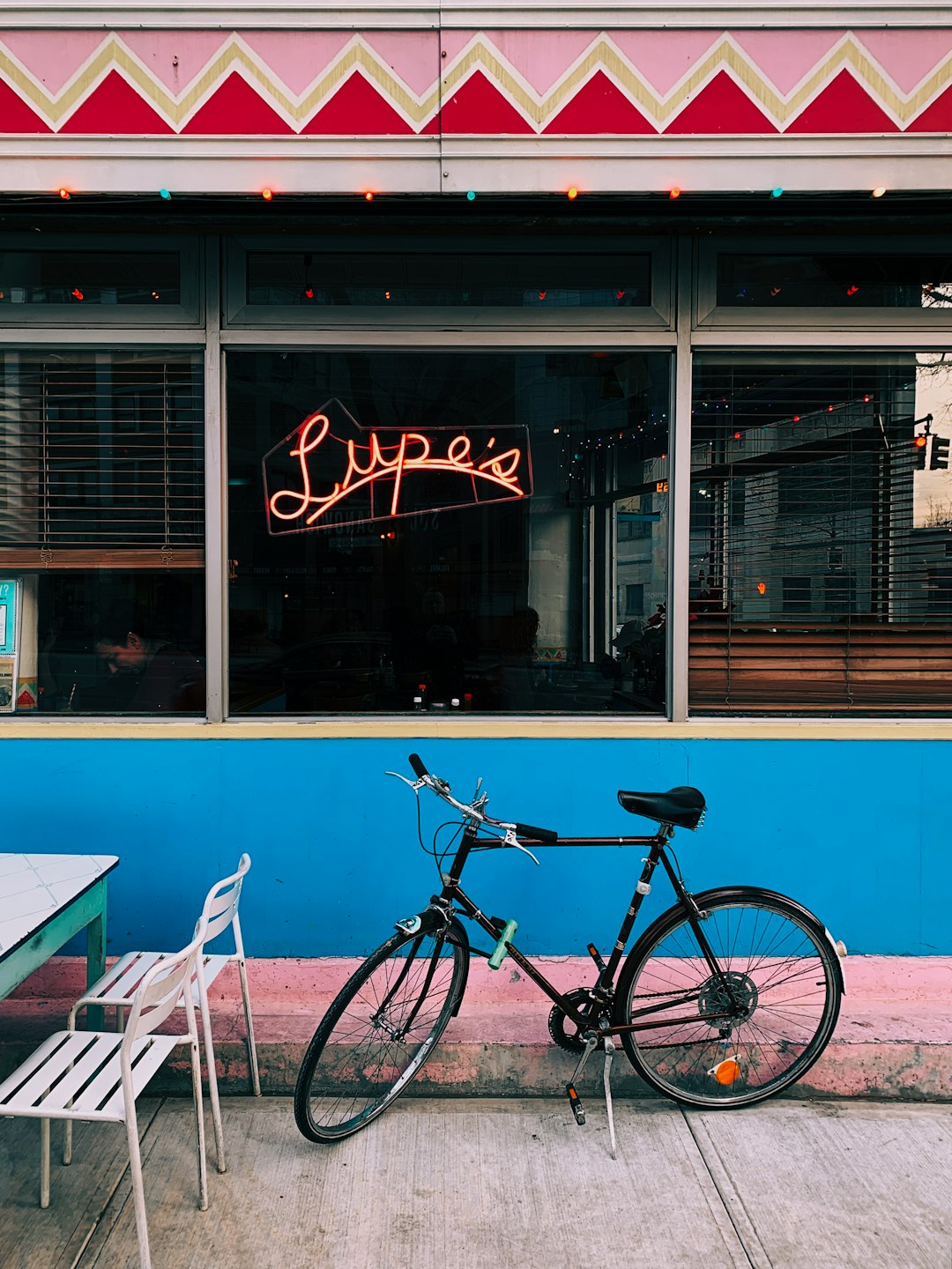 black bicycle parked near restaurant