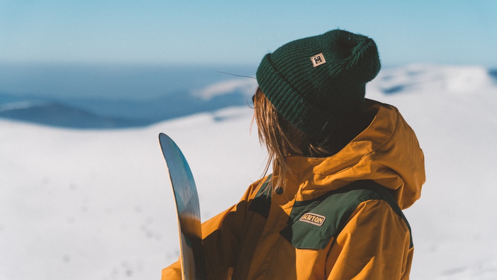 woman holding snowboard