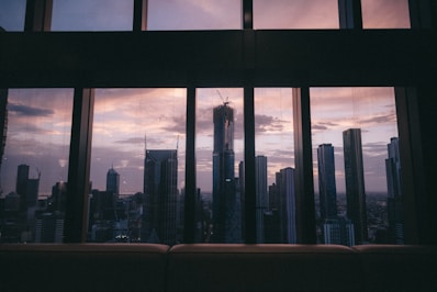 A cozy apartment with city skyline views at sunset.