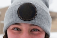 Detail shot of awoke’s signature logo embroidered on a soft gray beanie.