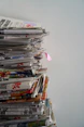 A stack of printed articles and posts arranged neatly on a table.