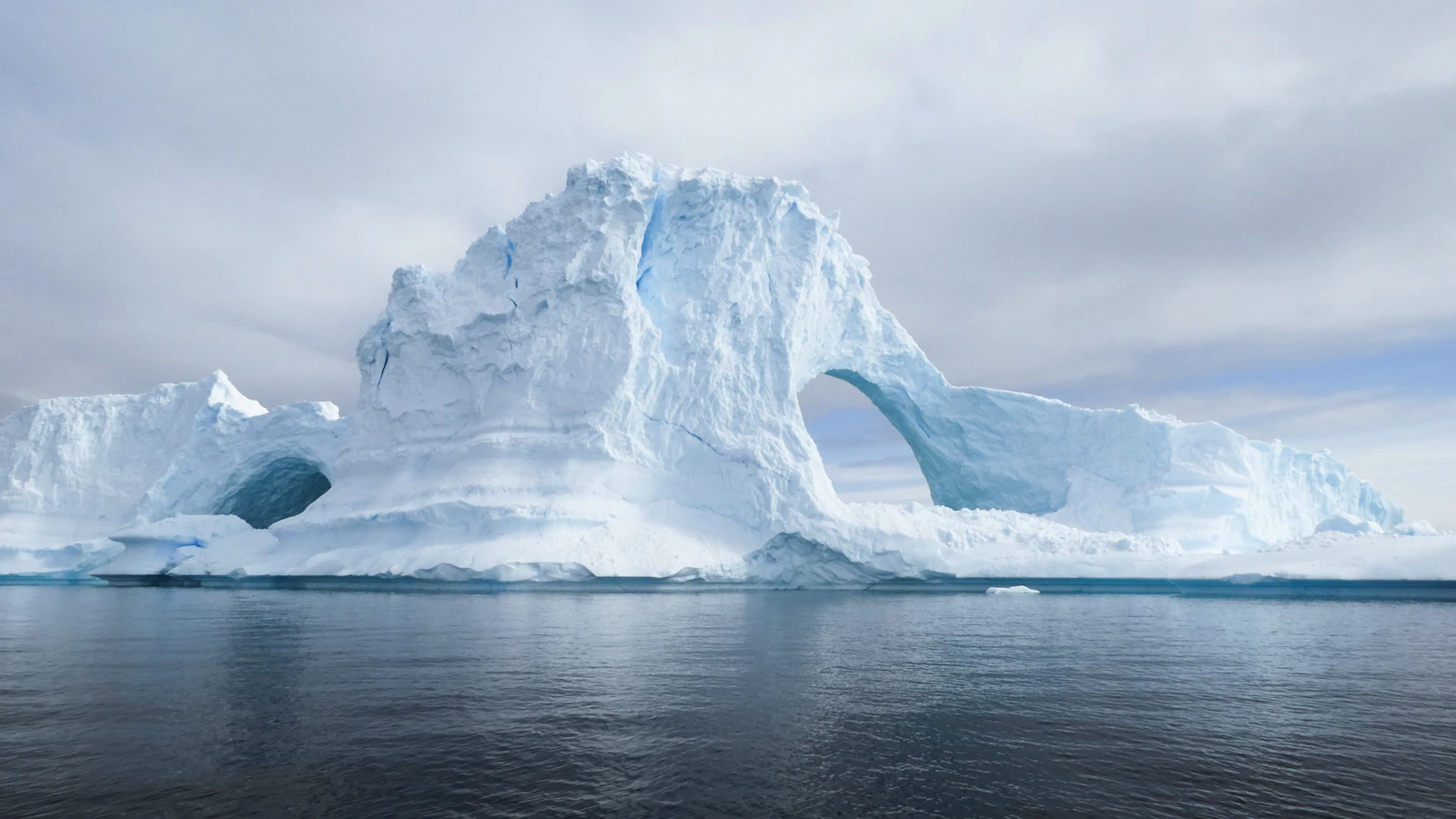A blue-white glacier under a clear polar sky