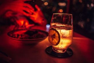 selective focus photography of drinking glass with cocktail drink on coaster
