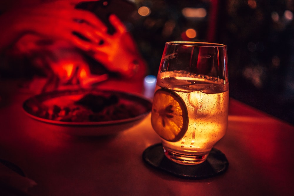 Selektive Fokusfotografie von Trinkglas mit Cocktailgetränk auf Untersetzer