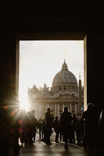 A crowd gathered in front of a government building at sunset.