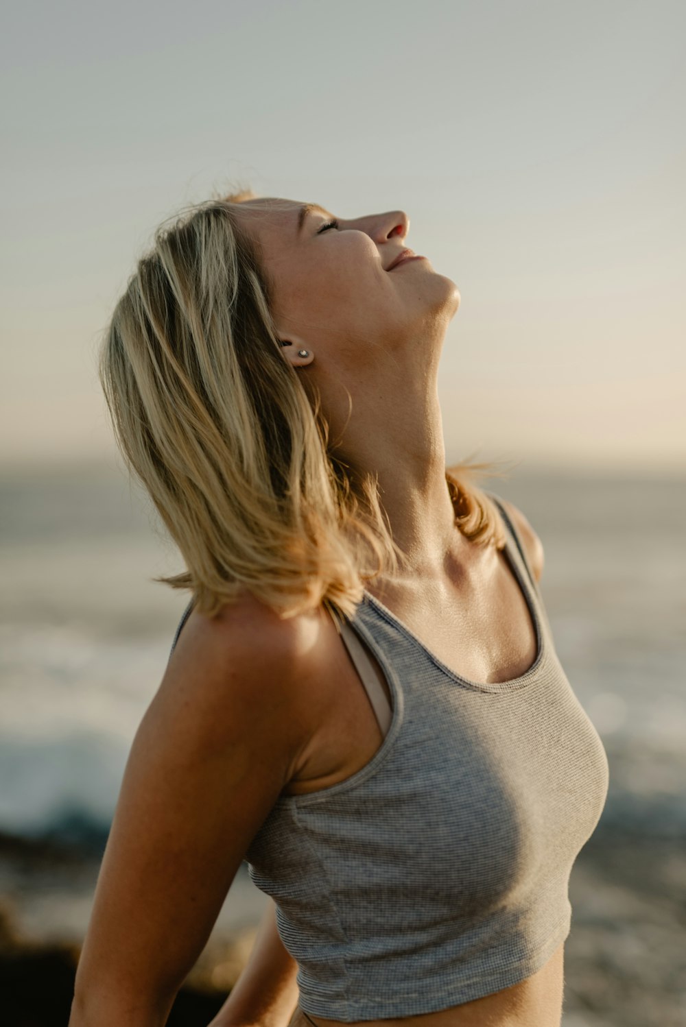 woman closing eyes while looking up