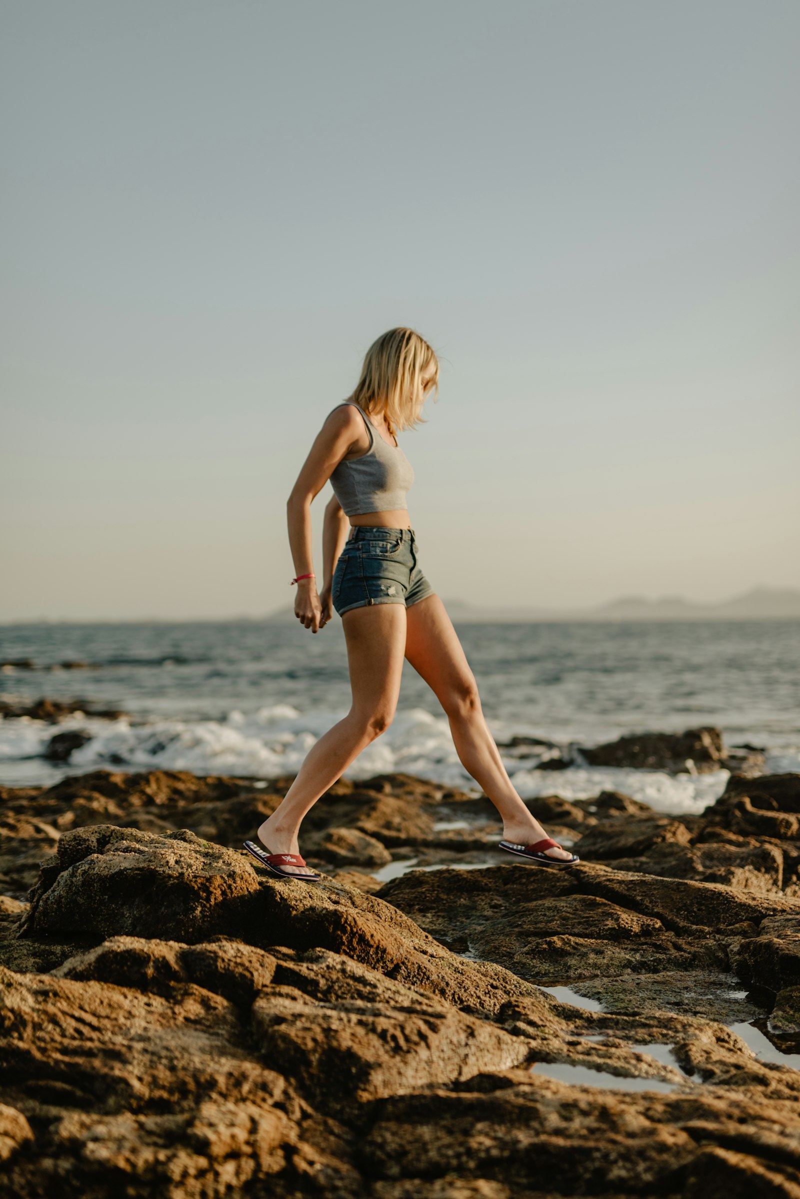 Sigma 50mm F1.4 DG HSM Art sample photo. Woman standing on rock photography