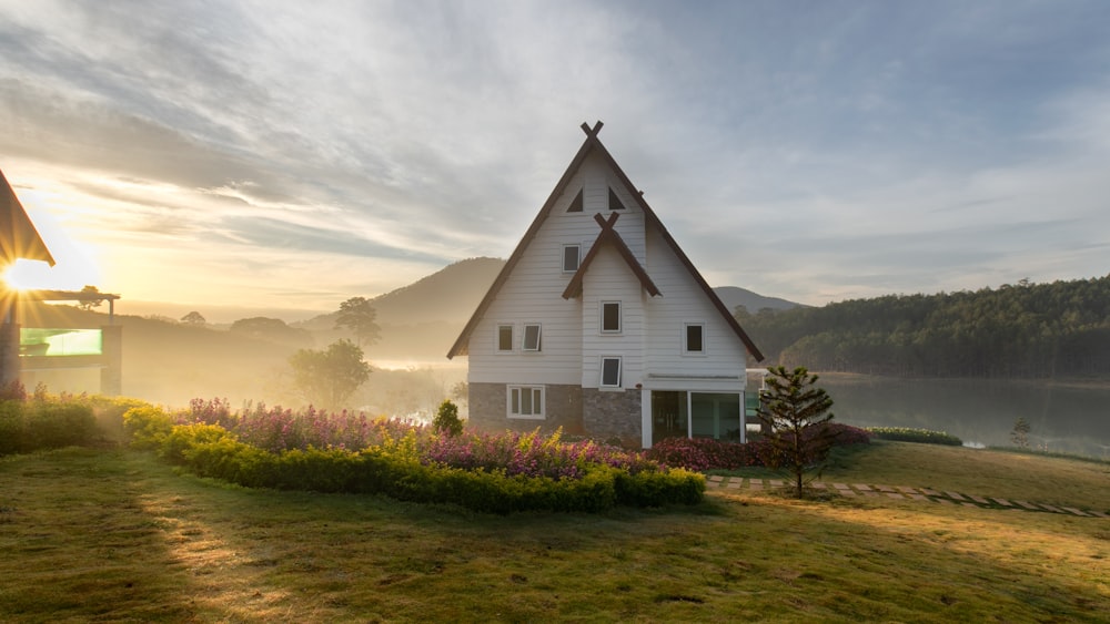 white painted house near body of water