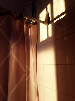 Image showing a technician carefully installing a SolarTek curtain in a modern living room.