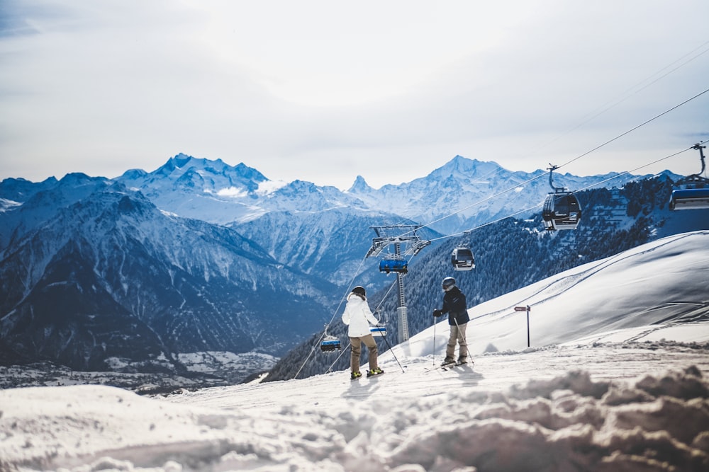 two persons standing under \cable cars