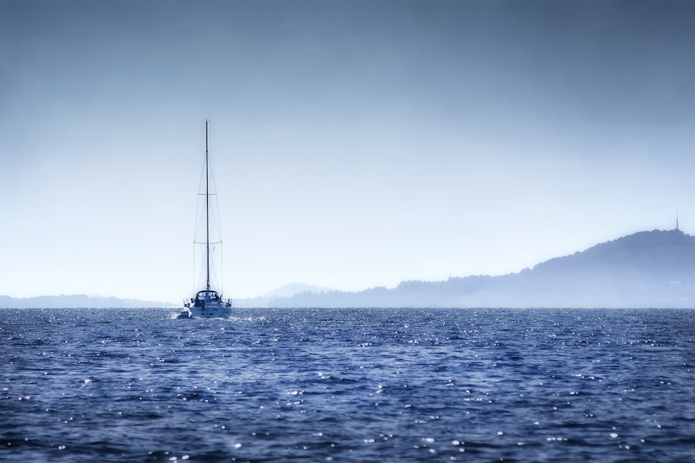 white boat under white sky