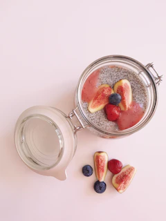 Overnight oats layered with chia seeds, blueberries, and sliced almonds in a glass jar
