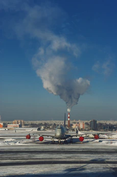 gray airplane under blue sky during daytime