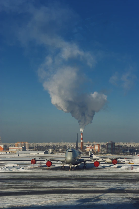 gray airplane under blue sky during daytime