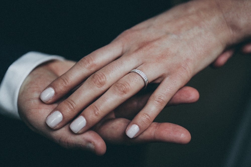 woman wearing silver-colored ring