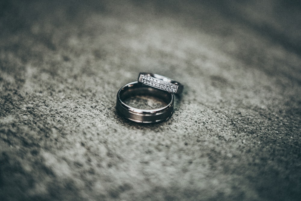 silver-colored rings on gray pavement