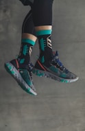 person wearing black-and-green Nike sneakers