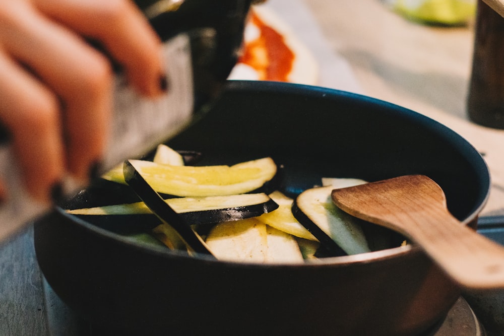 person cooking on black pot