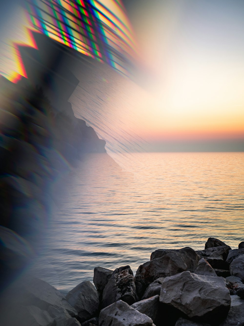 gray rocks on sea during golden hour