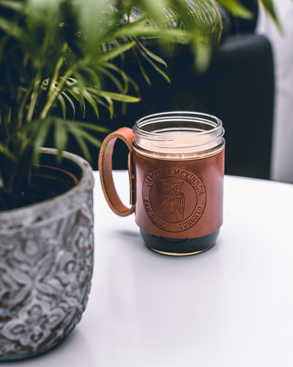 brown and clear glass mug on white surface