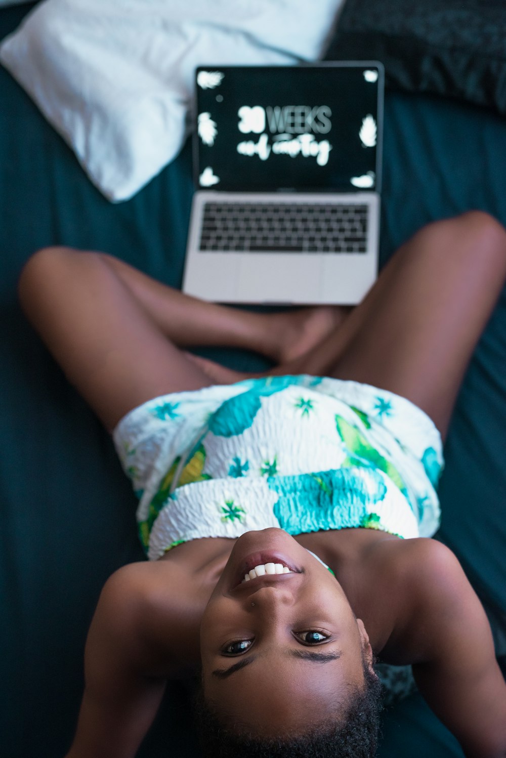 pregnant woman beside a turned-on TV