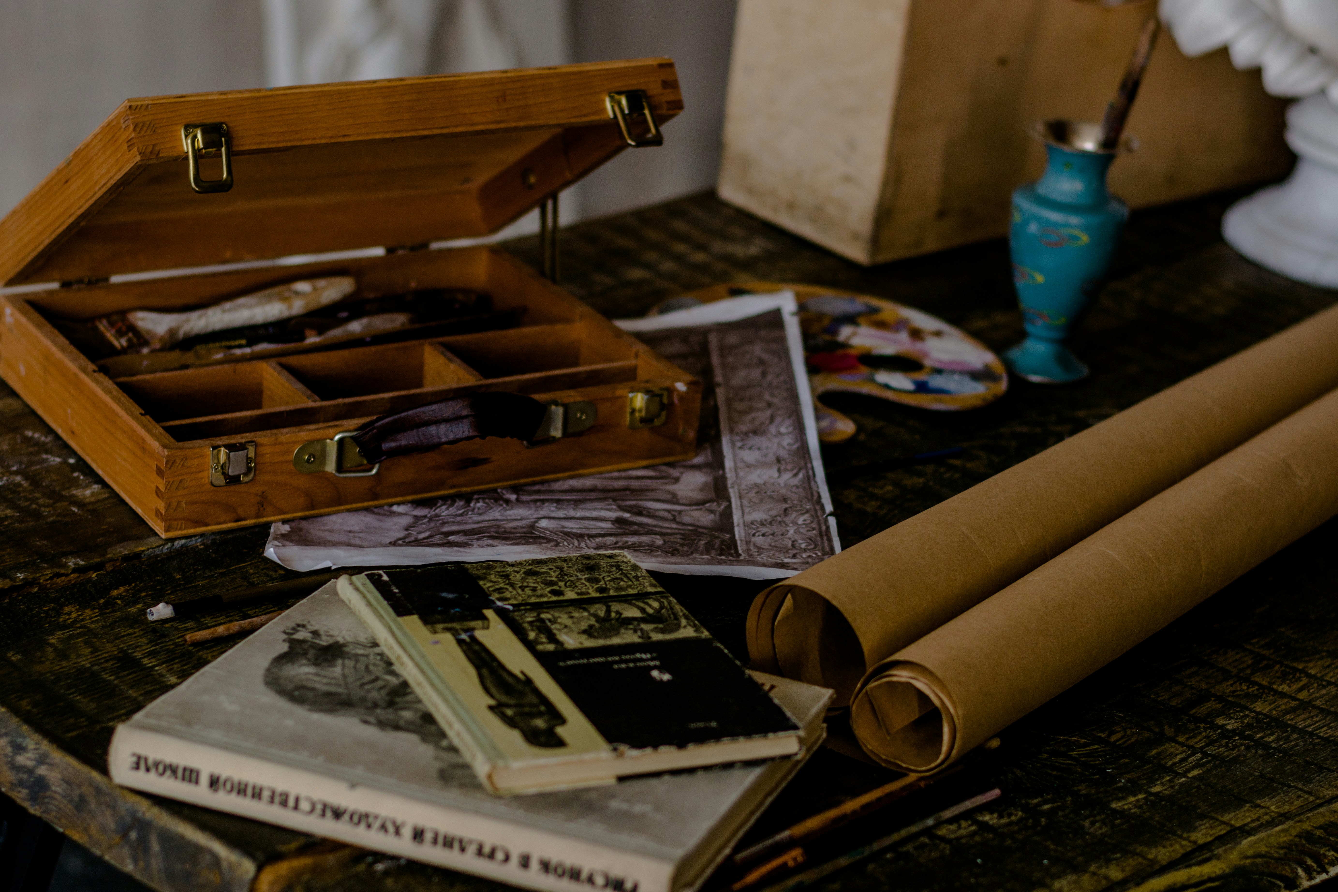 brown wooden box near books on table