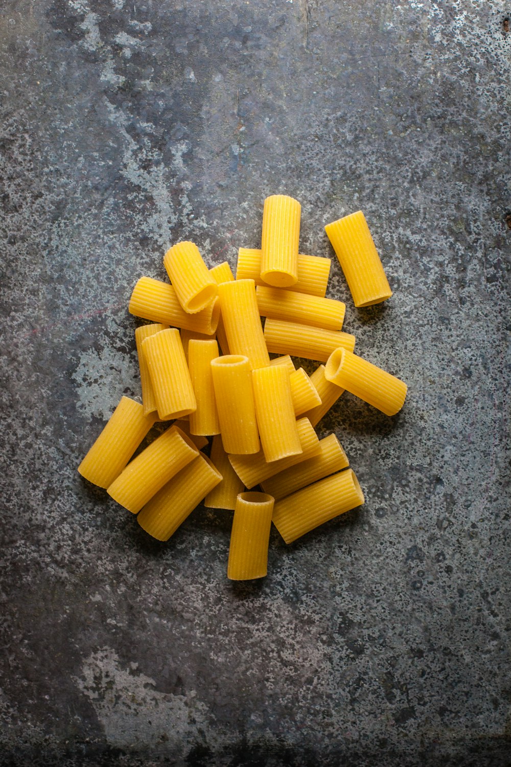 yellow pasta on gray surface