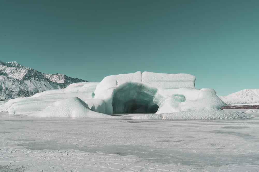 an ice cave in the middle of a snowy field