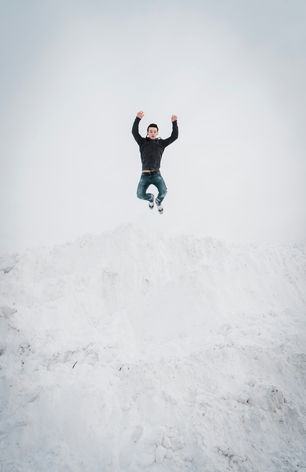 man jumping over snow