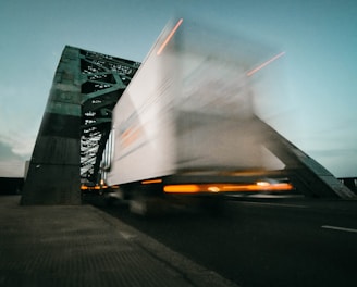 time lapse photography of truck going on bridge