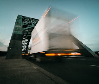 time lapse photography of truck going on bridge