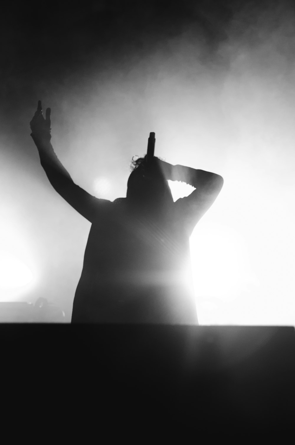 silhouette photo of person holding microphone