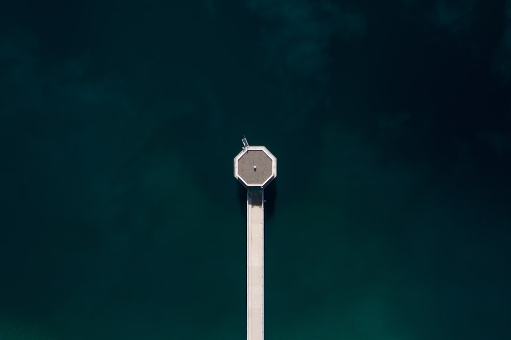 a stop sign on a pole in front of a body of water