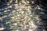Sunlight reflecting off ocean waves creating sparkling, dynamic textures.