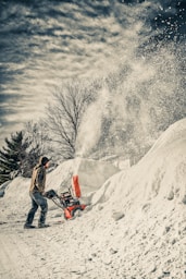 man using snow blower