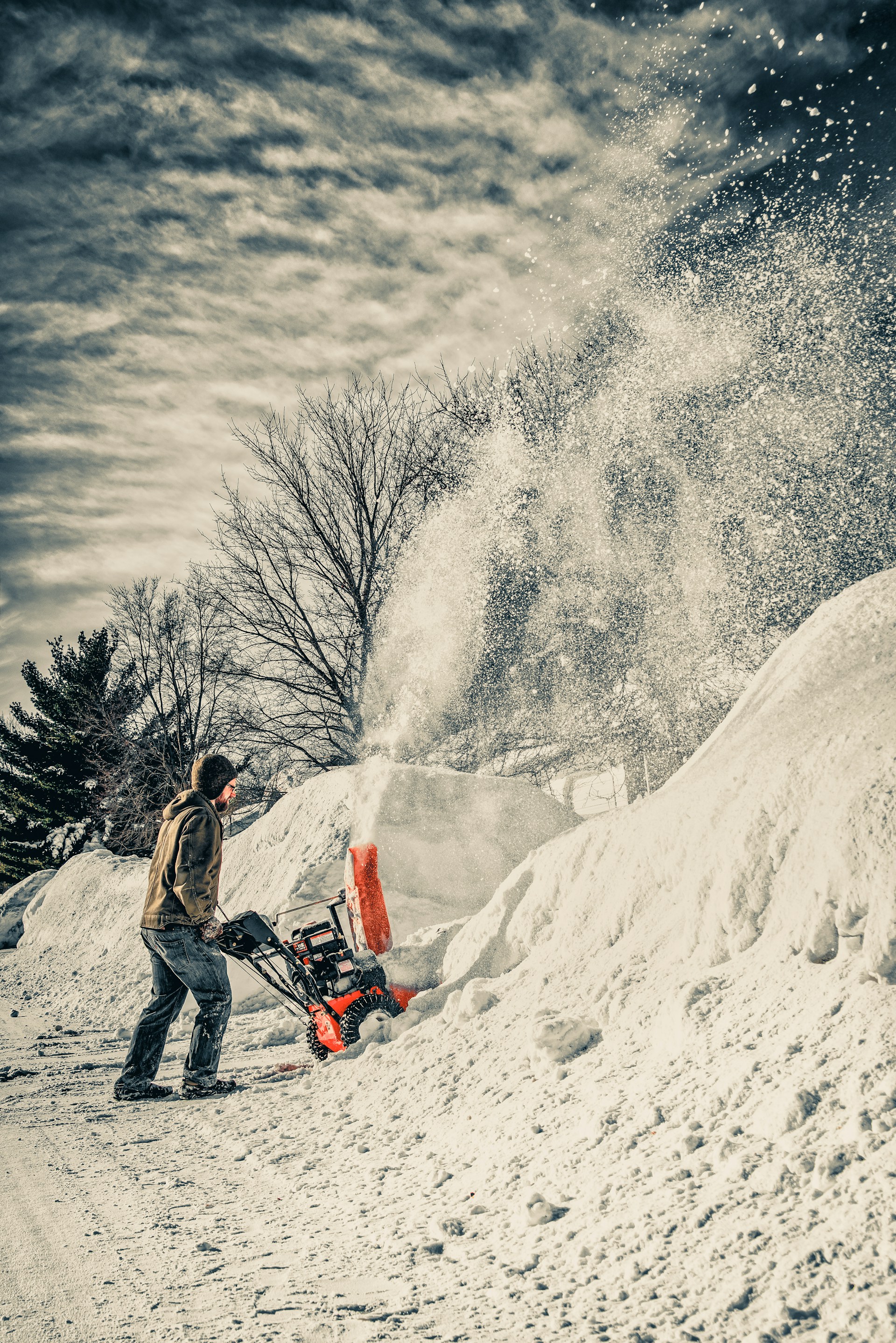 man using snow blower