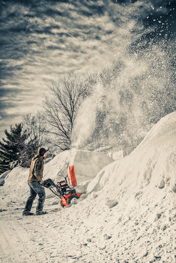 man using snow blower