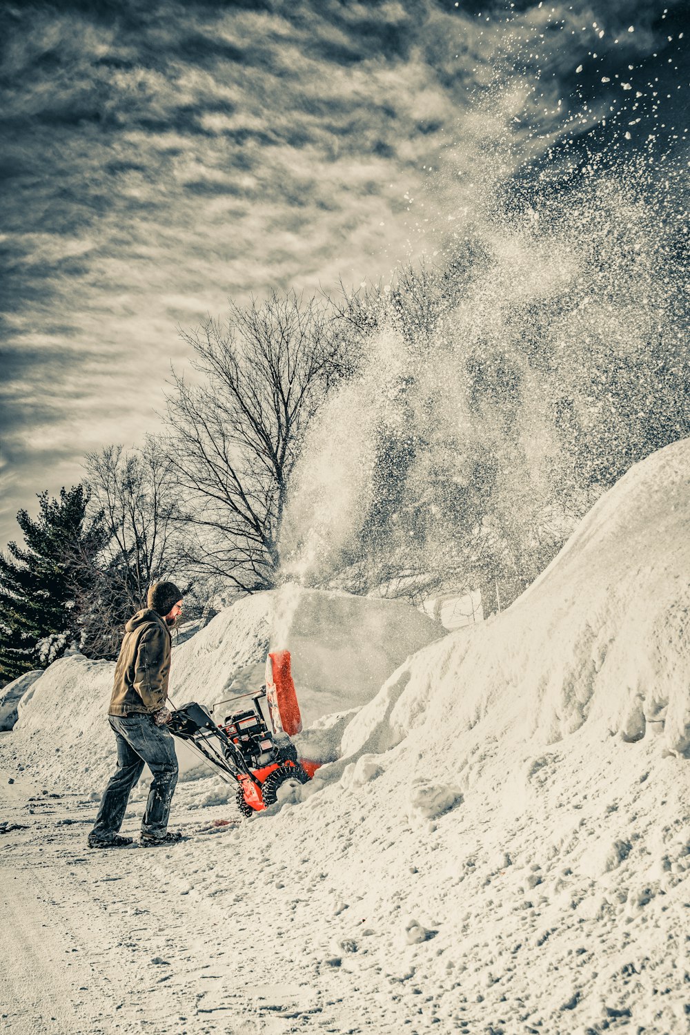 man using snow blower