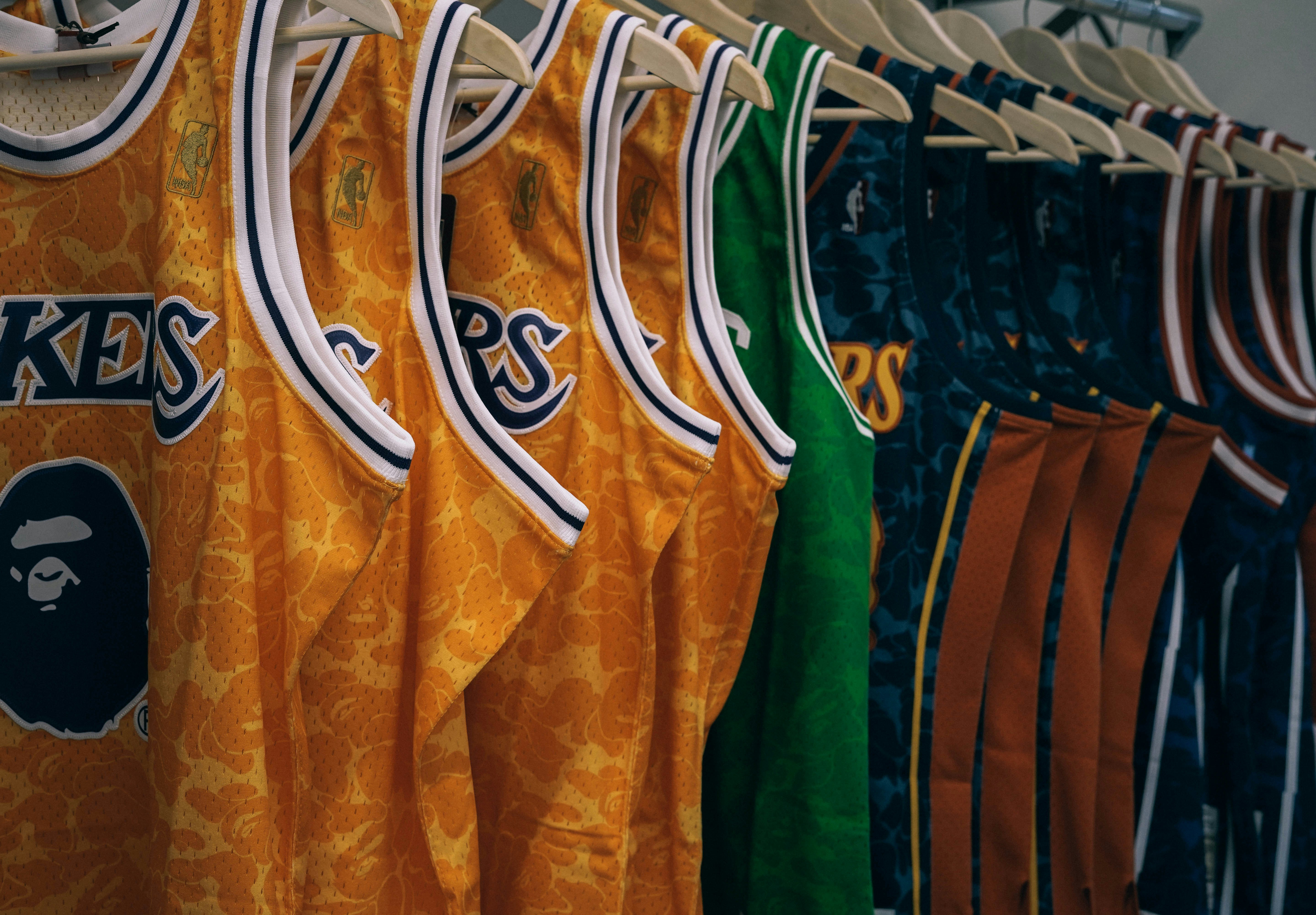 assorted NBA jerseys hanged on clothes hangers