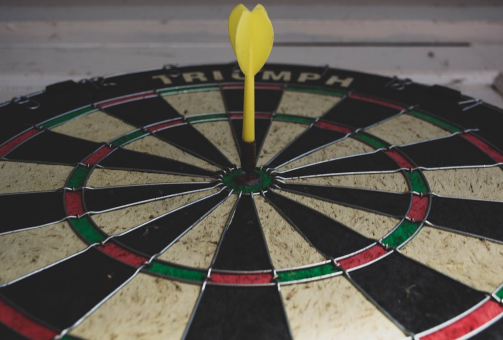 yellow dart pin on bullseye dart board