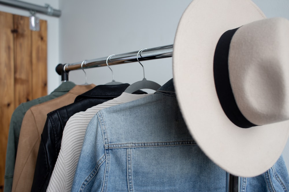 five tops hanging in cloth rack