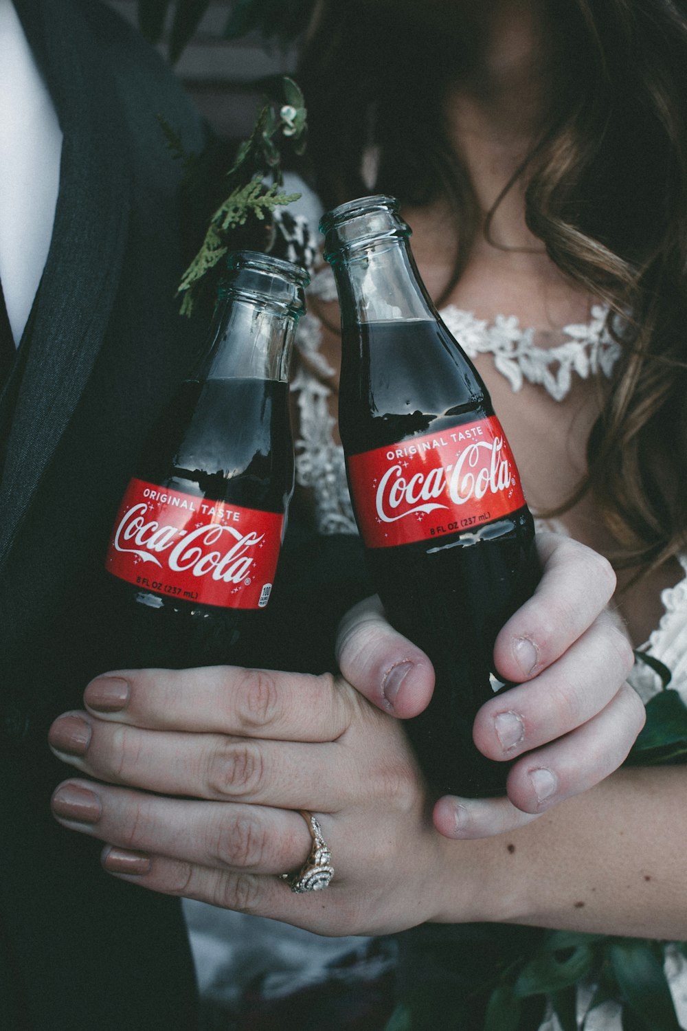 two Coca-Cola soda bottles